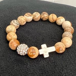 Bracelet with cross and rhinestone ball.